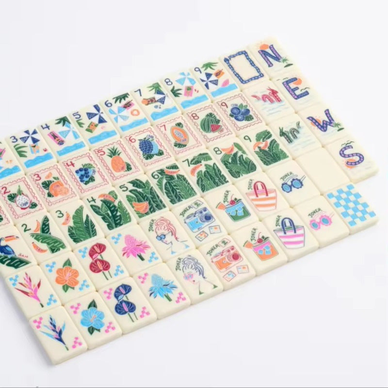 Tropic Getaway Mahjong Tiles Set — Cream‑ivory base tiles decorated with tropical fruits, toucan birds, palm foliage, hibiscus flowers and retro tourist jokers, American mahjong 160‑tile set