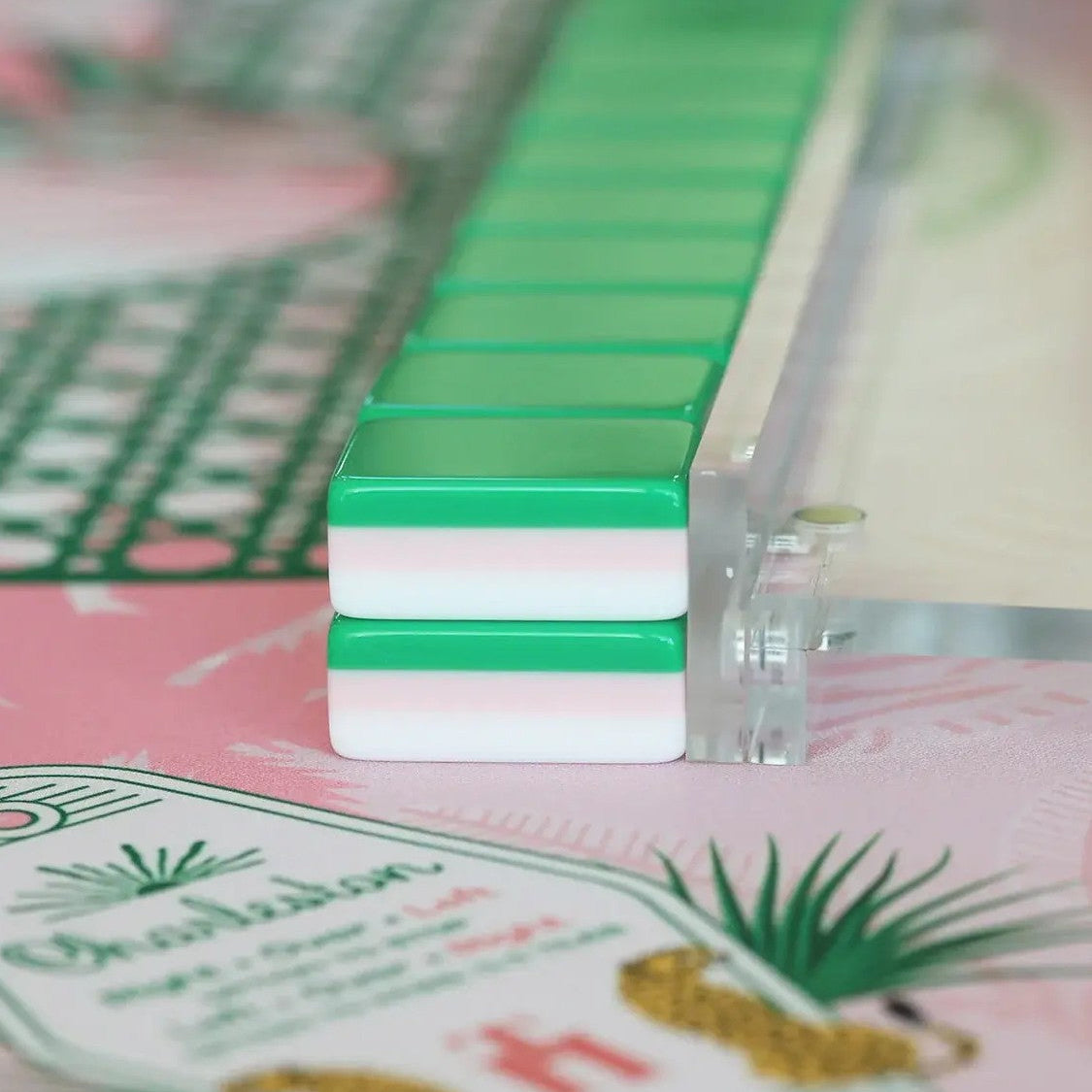 This fun retro‑vacation style mahjong set features stunning three‑layer tile backs in green‑pink‑white gradient, paired with hand‑drawn tropical artwork across tile faces. Enjoy playful joker tiles featuring flamingos, palm trees, retro cars, poolside cocktails, pineapples and swim‑suit motifs. Suits include shell‑styled dots, banana‑leaf bamboo, tropical floral character tiles, decorative tropical‑theme wind tiles and vivid bird accents. Complete 166‑tile set fully compliant with official American mahjong