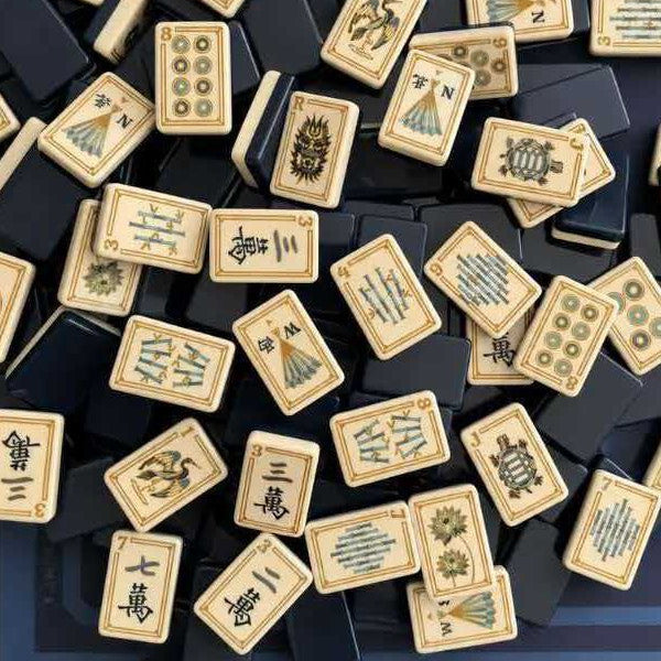 Imperial Navy mahjong overhead assortment, cream gold‑framed tiles featuring crane, dragon, turtle, lotus, bamboo stick and fan wind motifs, solid glossy navy‑blue backs, premium heritage American mahjong display