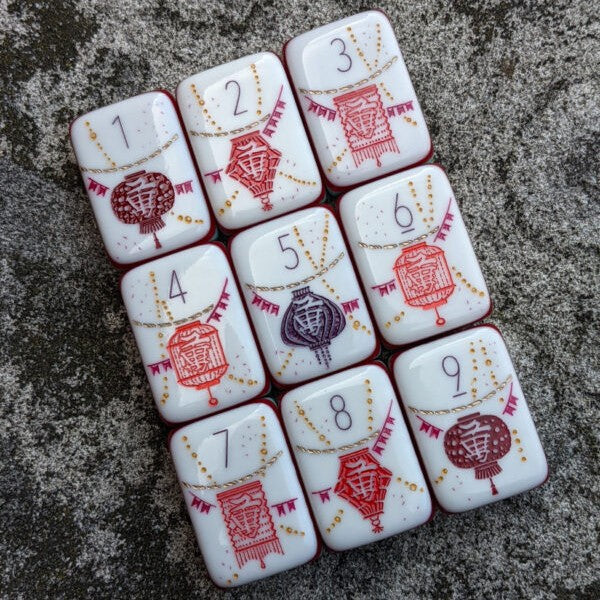 Rainbow Voyage Mahjong Tiles Set — Amber‑orange backs, multi‑layer rainbow striped sides, ivory fronts with hot‑air balloon, dragon, lantern, cherry‑blossom bee and matryoshka nesting‑doll joker American mahjong tiles