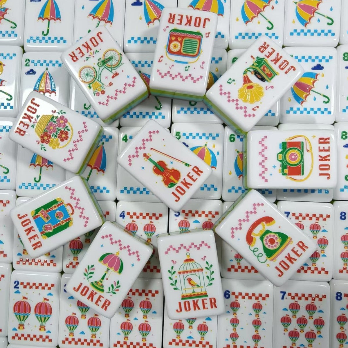 Full layout of Retro Nostalgia American mahjong tiles, ten vintage jokers in first column, N/E/S/W rainbow wind tiles, black cat cracks 1-9, umbrella bamboos 1-9, hot air balloon dots 1-9, butterfly and wreath flower tiles, pink pearlescent backs