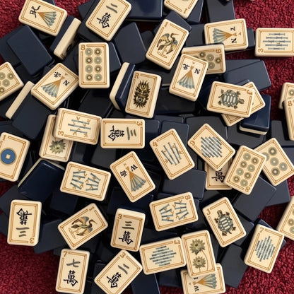 Evoking timeless oriental elegance, this Imperial Navy American mahjong set features luxe gold‑bordered cream tile faces decorated with classic East‑Asian wildlife and botanical art. Graceful cranes, symbolic turtle jokers, fierce dragon motifs, lush lotus florals, coin‑styled dot tiles and ornate fan‑shaped wind tiles elevate every suit. Rich deep navy‑blue high‑gloss tile backs deliver a premium, sophisticated finished look.