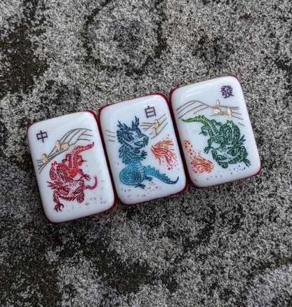 Rainbow Voyage Mahjong Tiles Set — Amber‑orange backs, multi‑layer rainbow striped sides, ivory fronts with hot‑air balloon, dragon, lantern, cherry‑blossom bee and matryoshka nesting‑doll joker American mahjong tiles