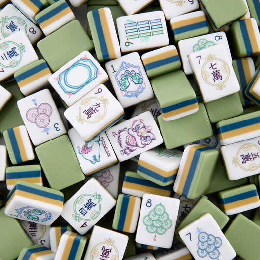 Immerse yourself in delicate chinoiserie charm with this Pagoda Garden American mahjong set. Soft‑toned tile faces showcase elegant pagoda architecture, lush peony floral illustrations, whimsical elephant‑themed jokers, festive lion‑dance motifs and hand‑drawn styled suit patterns. Distinct multi‑layer olive‑green, mustard‑yellow and navy stacked tile backs deliver a warm, earth‑toned premium look.