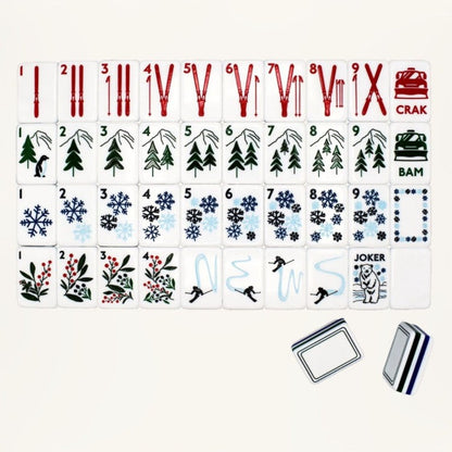 Frosty Peak mahjong full flat‑lay layout, complete 160‑tile winter alpine set, skis, snowflakes, mountain pine trees, skier graphics, polar bear joker, multi‑stripe layered backs, American mahjong tiles