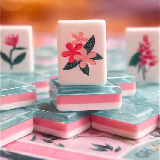 Close-up of Tropical Floral American mahjong tile with plumeria flower art, stacked tiles showing teal pink layered resin sides