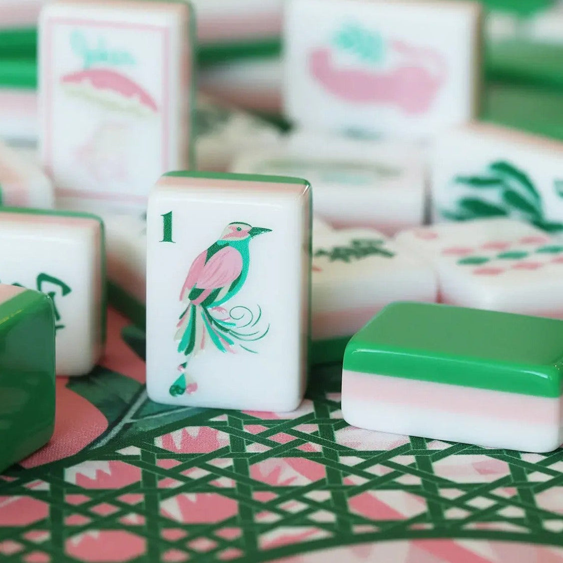 This fun retro‑vacation style mahjong set features stunning three‑layer tile backs in green‑pink‑white gradient, paired with hand‑drawn tropical artwork across tile faces. Enjoy playful joker tiles featuring flamingos, palm trees, retro cars, poolside cocktails, pineapples and swim‑suit motifs. Suits include shell‑styled dots, banana‑leaf bamboo, tropical floral character tiles, decorative tropical‑theme wind tiles and vivid bird accents. Complete 166‑tile set fully compliant with official American mahjong 