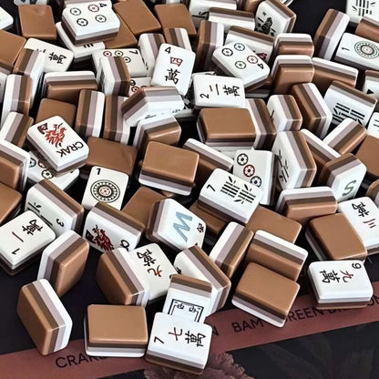 Wildwood Bear mahjong scattered close‑up view, mocha brown multi‑layer tile backs, wild flower suit tiles, dragon tile, nature‑themed custom American mahjong pieces