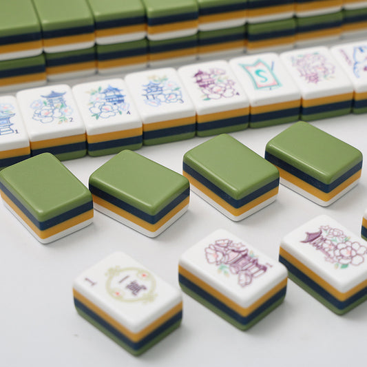 Pagoda Garden mahjong partial row view, solid olive‑green stacked tile backs, one‑wan character tile, north wind tile and pagoda‑peony seasonal tile, close‑up of custom art mahjong pieces