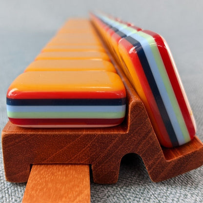 Rainbow Voyage Mahjong Tiles Set — Amber‑orange backs, multi‑layer rainbow striped sides, ivory fronts with hot‑air balloon, dragon, lantern, cherry‑blossom bee and matryoshka nesting‑doll joker American mahjong tiles