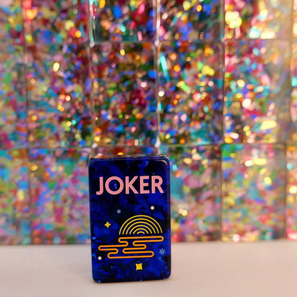 Scattered Confetti Sapphire American mahjong tiles on white background, deep blue resin tiles with embedded rainbow confetti flakes and bright neon pop art graphics