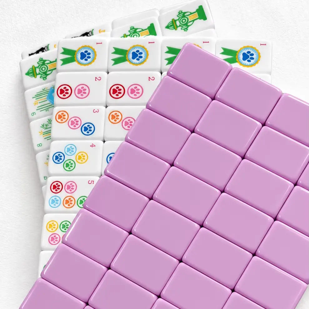 Pet cat & dog mahjong neatly arranged inside clear storage tray, poodle, spaniel dog patterns, colorful paw print suit tiles, pink backing mahjong tiles