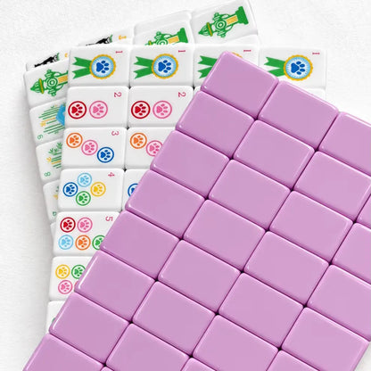 Pet cat & dog mahjong neatly arranged inside clear storage tray, poodle, spaniel dog patterns, colorful paw print suit tiles, pink backing mahjong tiles