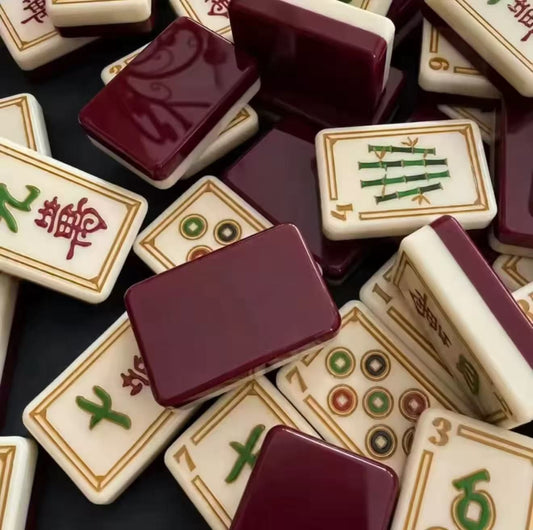Evoking timeless oriental elegance, this Imperial Grove American mahjong set features luxe gold‑bordered cream tile faces decorated with classic East‑Asian wildlife and botanical art. Graceful cranes, symbolic turtle jokers, fierce dragon motifs, lush lotus florals and ornate fan‑styled wind tiles elevate every suit. Rich deep burgundy high‑gloss tile backs deliver a premium, sophisticated finished look.