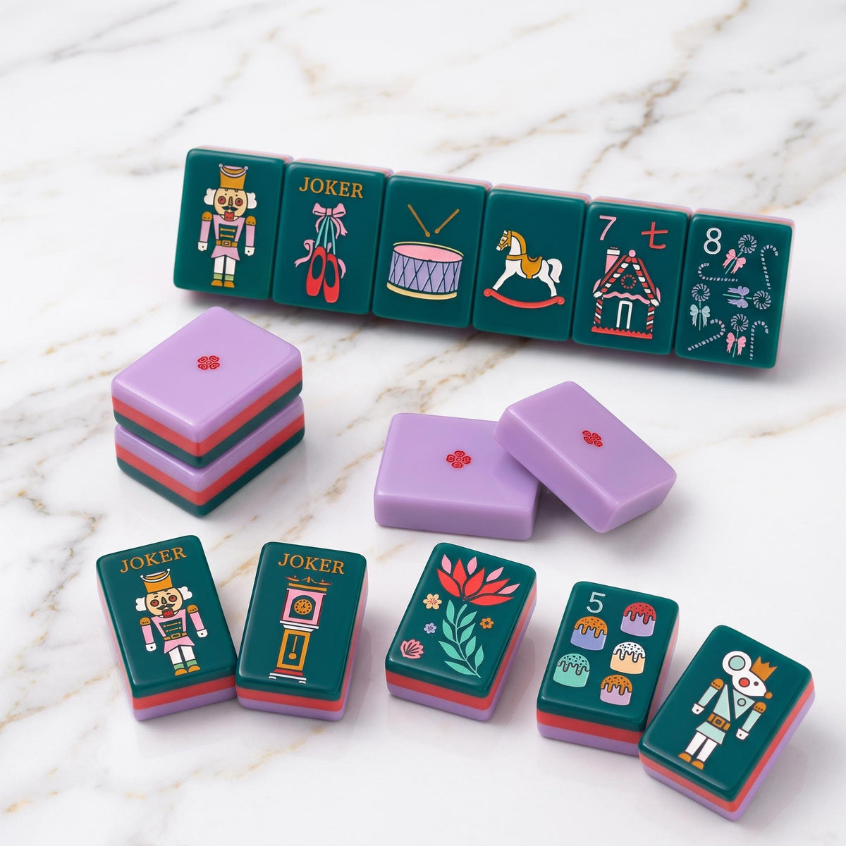 The most magical mahjong set of the season.The Holiday Nutcracker is a limited-edition collector's piece featuring rich evergreen melamine tiles adorned with hand-illustrated Christmas art from the iconic nutcracker soldier Jokers and pink ballet slipper Jokers to gingerbread house Craks, frosted cake Dots, ballerina winds (NEWS), poinsettia flowers, Christmas trees, and grandfather clocks. The ultimate holiday gift for the American Mahjong lover in your life.