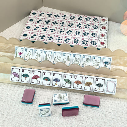 American mahjong set displayed with acrylic tile racks, mahjong tiles arranged neatly showing fan, bamboo and circle patterns inside storage box