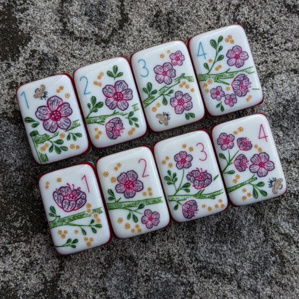 Rainbow Voyage Mahjong Tiles Set — Amber‑orange backs, multi‑layer rainbow striped sides, ivory fronts with hot‑air balloon, dragon, lantern, cherry‑blossom bee and matryoshka nesting‑doll joker American mahjong tiles
