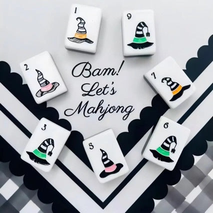 Spooky Hallow Mahjong Tiles Set — Solid black backs, white tile fronts decorated with ghost jokers, witch hats, magic cauldrons, owls, spider‑web winds and coffin‑floral Halloween‑themed American mahjong tiles