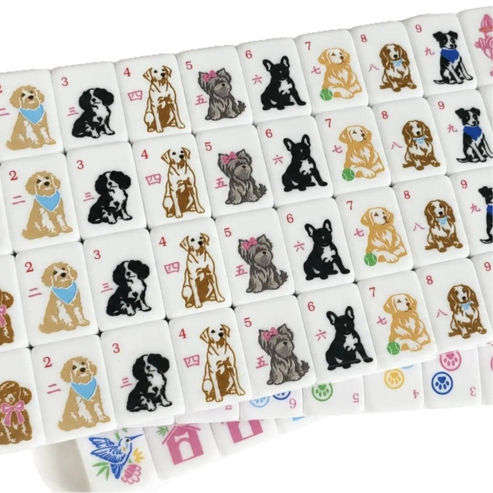 Overhead shot of scattered pet mahjong tiles, dog, cat joker, paw print and bird patterns, glossy pink tile backs