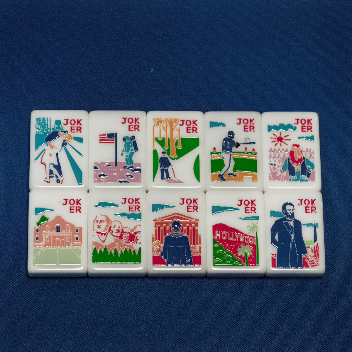 Flat lay of custom American Road Trip joker tiles set, featuring Hollywood sign, Mount Rushmore, astronaut, baseball player and historic US landmark illustrations
