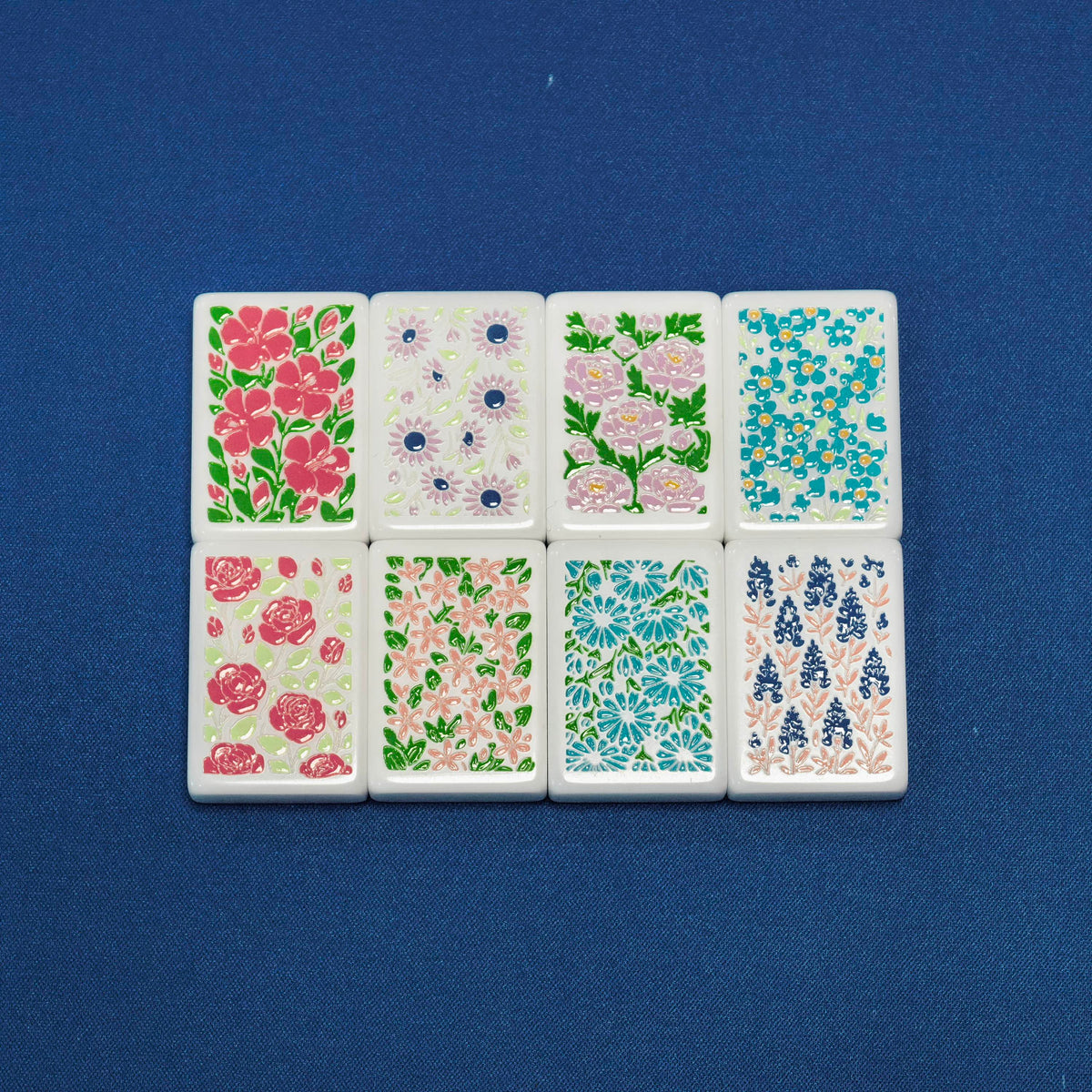 Flat lay of American Road Trip mahjong flower tiles, 8 pieces of vintage multi-color floral botanical artwork on white resin tiles