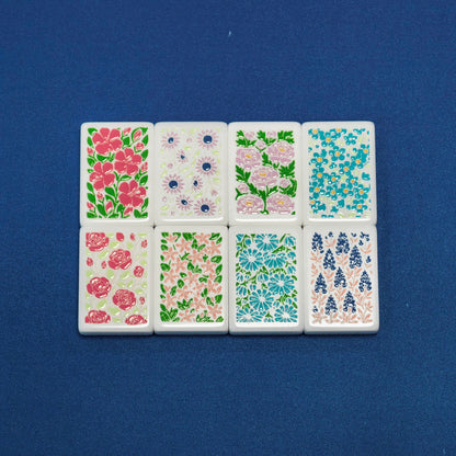 Flat lay of American Road Trip mahjong flower tiles, 8 pieces of vintage multi-color floral botanical artwork on white resin tiles