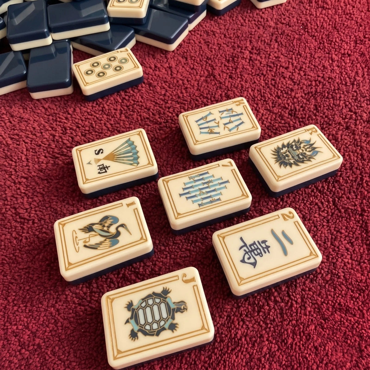 Evoking timeless oriental elegance, this Imperial Navy American mahjong set features luxe gold‑bordered cream tile faces decorated with classic East‑Asian wildlife and botanical art. Graceful cranes, symbolic turtle jokers, fierce dragon motifs, lush lotus florals, coin‑styled dot tiles and ornate fan‑shaped wind tiles elevate every suit. Rich deep navy‑blue high‑gloss tile backs deliver a premium, sophisticated finished look.