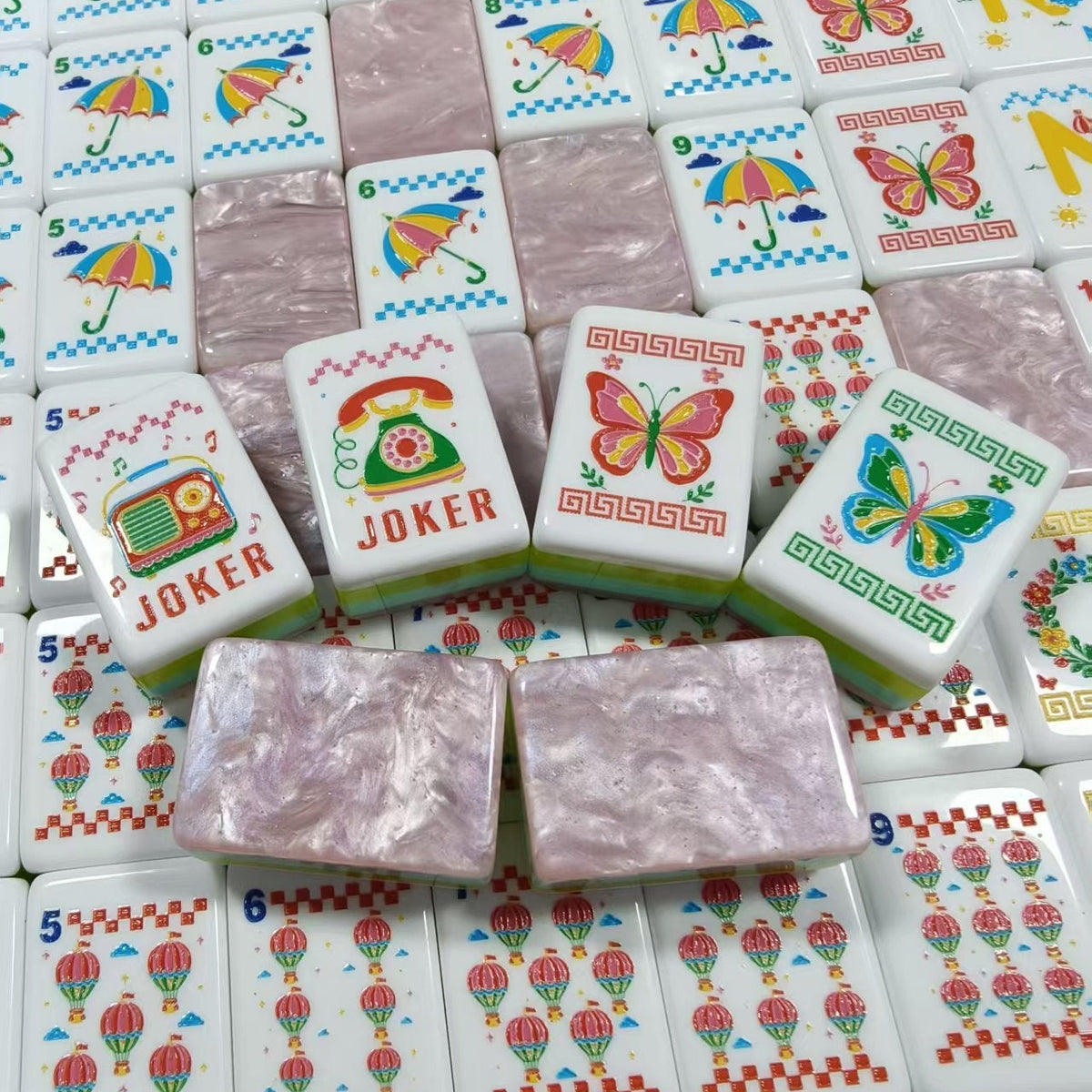 Scattered Retro Nostalgia mahjong tiles, white faces with macaron dot tiles, pizza tile, umbrella bamboo tiles, black cat crack tiles, butterfly flower tiles, rainbow N/E/W/S wind tiles and pink pearlescent marble backs with aqua-lime-pink side stripes