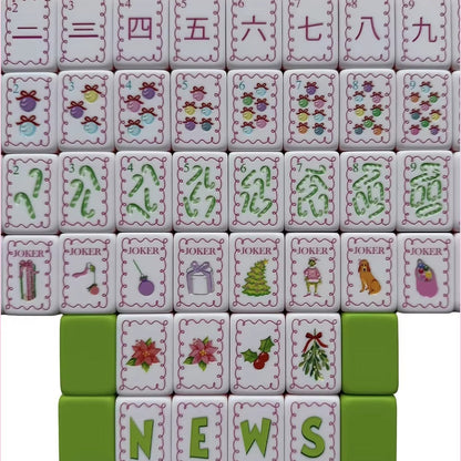 Flat lay display of full Christmas Grinch mahjong set, showing complete suit tiles, wind tiles and holiday joker tiles with pink scalloped borders