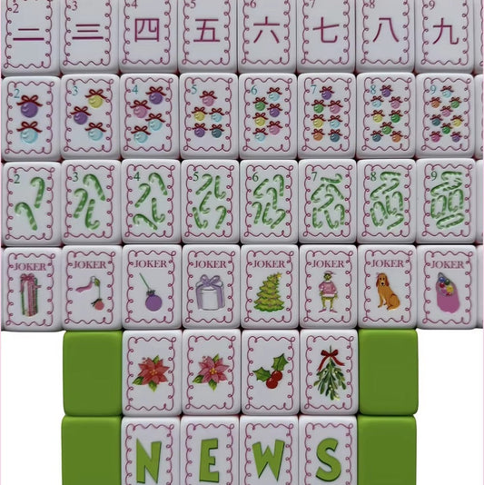 Flat lay display of full Christmas Grinch mahjong set, showing complete suit tiles, wind tiles and holiday joker tiles with pink scalloped borders