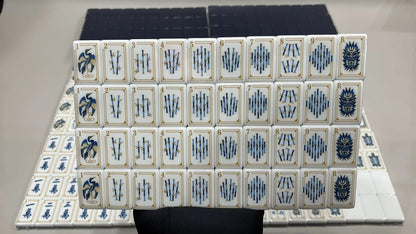 Evoking timeless oriental elegance, this Imperial Navy American mahjong set features luxe gold‑bordered cream tile faces decorated with classic East‑Asian wildlife and botanical art. Graceful cranes, symbolic turtle jokers, fierce dragon motifs, lush lotus florals, coin‑styled dot tiles and ornate fan‑shaped wind tiles elevate every suit. Rich deep navy‑blue high‑gloss tile backs deliver a premium, sophisticated finished look.