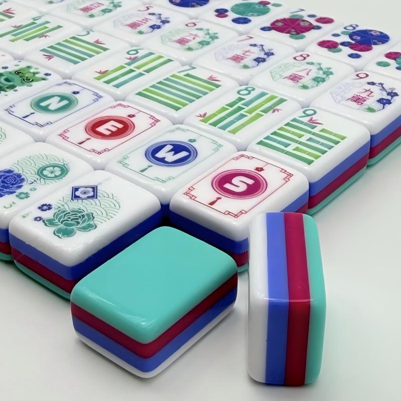 Retro Flair mahjong partial row view, wind and dragon tiles, floral bamboo suits, unique multi‑layer teal‑magenta‑blue stacked tile sides and backs, custom art American mahjong tiles