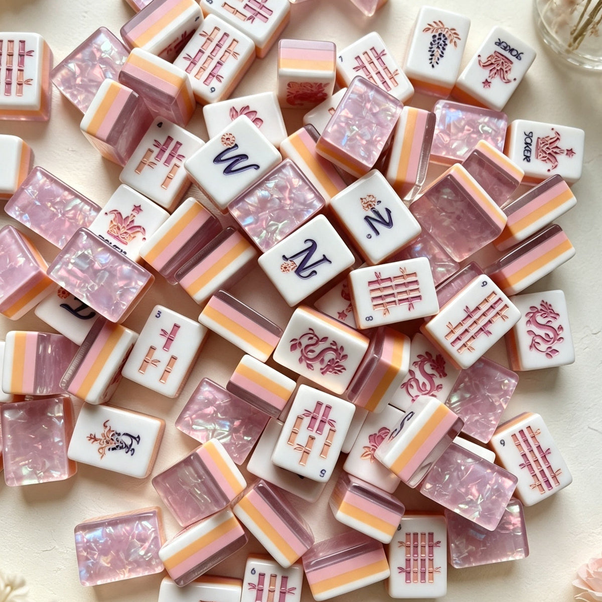 Purple Crown Pearl American mahjong tiles, purple iridescent pearl resin backs, embossed phoenix, peony and crown joker tiles, styled with pink roses and dried baby's breath on cream background