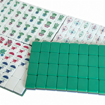 The Teal Lagoon Heritage American Mahjong Set by USA Mahjong Co., featuring deep blue-green acrylic tiles with gold inlays.