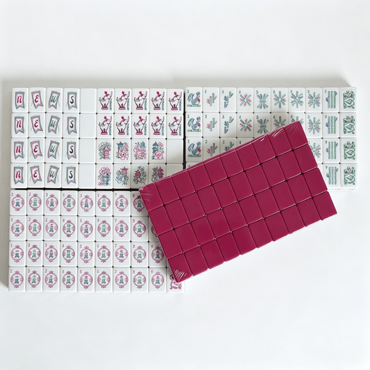 Artisan American Mahjong Set featuring hand-painted magenta tiles with detailed elephant engravings and grey-blue backs.