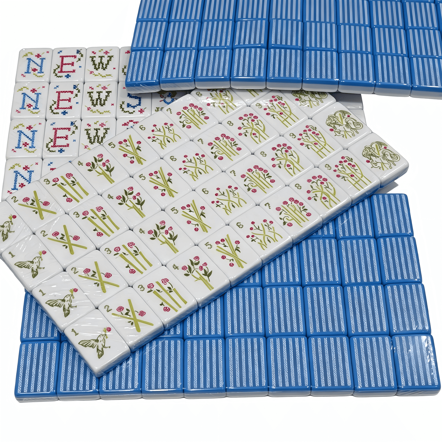 Detailed view of USA Mahjong Co. Sky Linen American Mahjong Set with blue and white striped acrylic tiles and gold inlays.