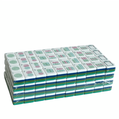 The Teal Lagoon Heritage American Mahjong Set by USA Mahjong Co., featuring deep blue-green acrylic tiles with gold inlays.