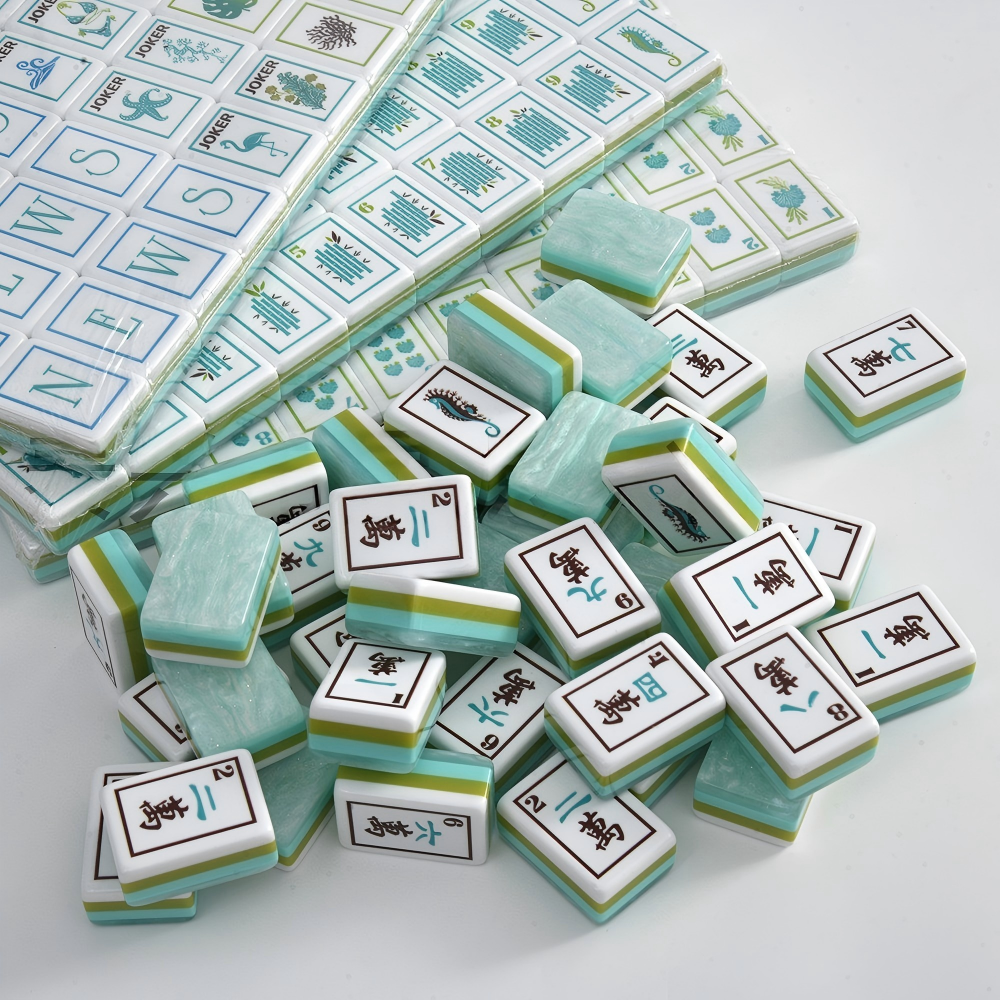 A breath of fresh sea air for your mahjong table. The Coastal Mist features soft mint-marbled acrylic backs with signature multi-layer side stripes in turquoise, lime, and white paired with crisp white faces and exclusive ocean-themed Joker and Flower illustrations. It's coastal elegance meets full NMJL tournament functionality.