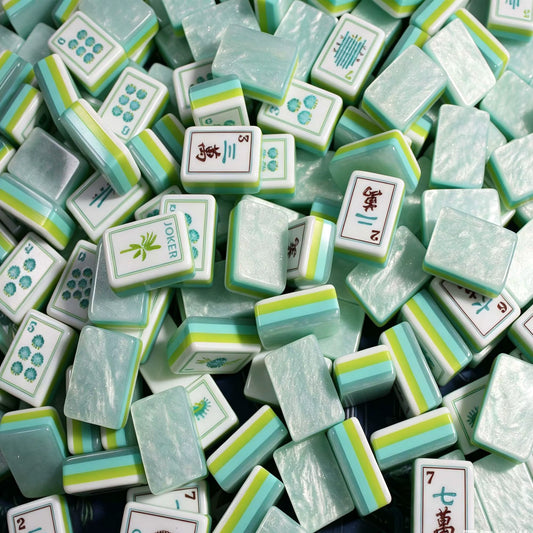 A breath of fresh sea air for your mahjong table. The Coastal Mist features soft mint-marbled acrylic backs with signature multi-layer side stripes in turquoise, lime, and white paired with crisp white faces and exclusive ocean-themed Joker and Flower illustrations. It's coastal elegance meets full NMJL tournament functionality.
