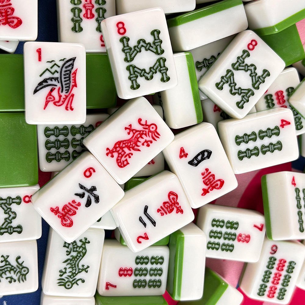 Premium Emerald Line American Mahjong Set by USA Mahjong Co. with 166 tiles featuring green backs and detailed tile designs.