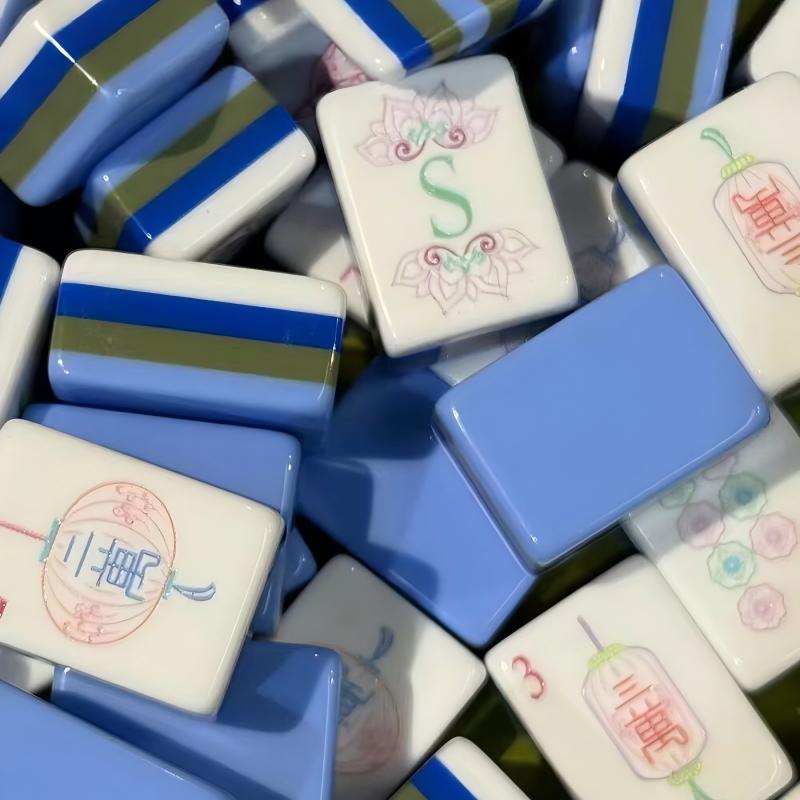 Lotus Lantern Mahjong Tiles Set — Glossy multi‑layer light‑blue backs, white tile faces with lantern‑styled characters, pastel florals, palm‑tree bamboos and decorative mask jokers, full 160‑tile American mahjong set