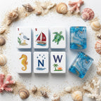 Coastal Mahjong Tiles Close-up - Seagull Sailboat Sea Turtle Seahorse and Tropical Wind Tiles on Sandy Background