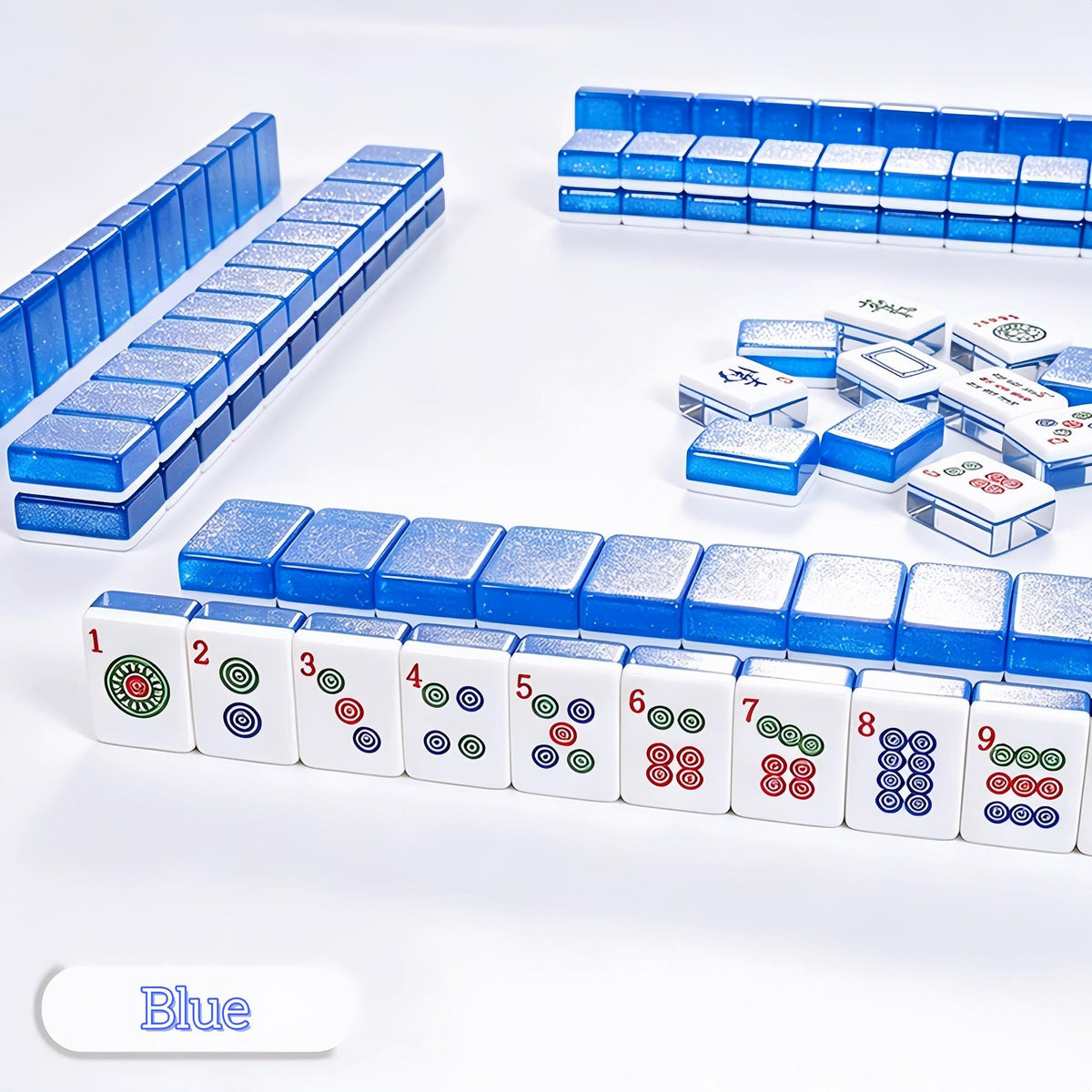 Crystal Shimmer Blue mahjong tiles arranged with daisy flowers and green vase, translucent blue glitter backs, white faces with Chinese character and wind tiles, bright sunlight American mahjong product shot