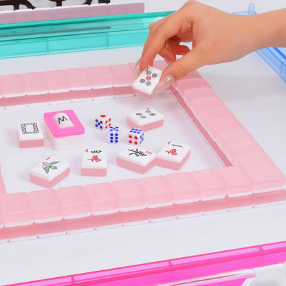 Hand picking pink Jelly Macaron translucent glossy mahjong tile during mahjong gameplay, pink mahjong wall, mahjong dice on white game table, jelly macaron style American mahjong set