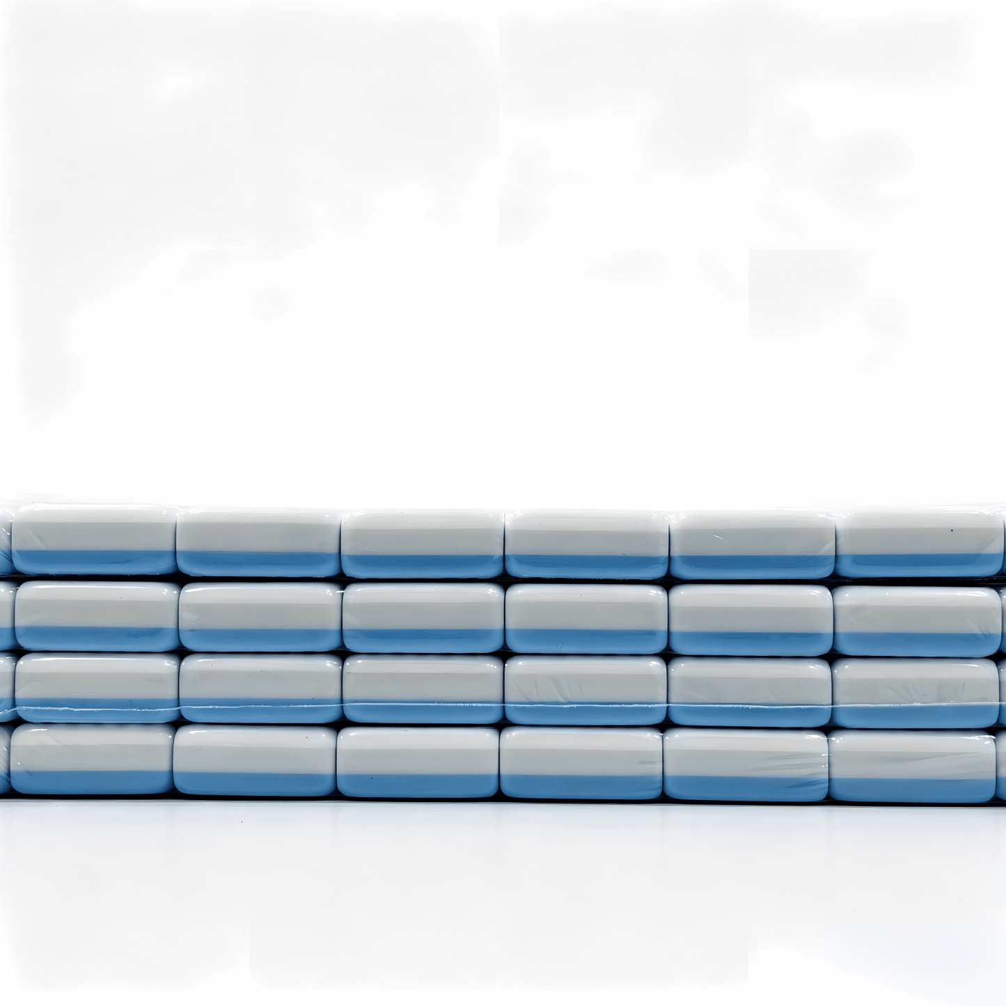 Side view of 32g blue-striped tiles from The Sky Linen American Mahjong Set by USA Mahjong Co., featuring weighted